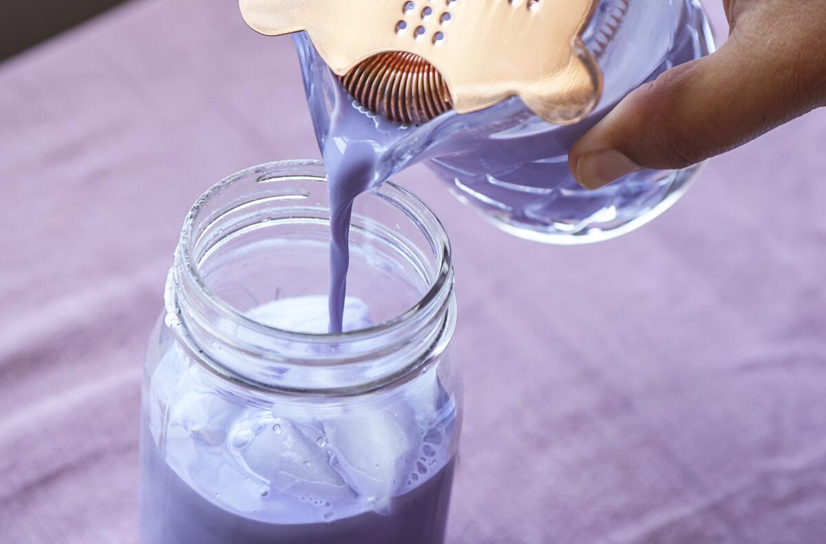 Strain the blueberry syrup and milk mixture and pour into a jar to prepare the drink.