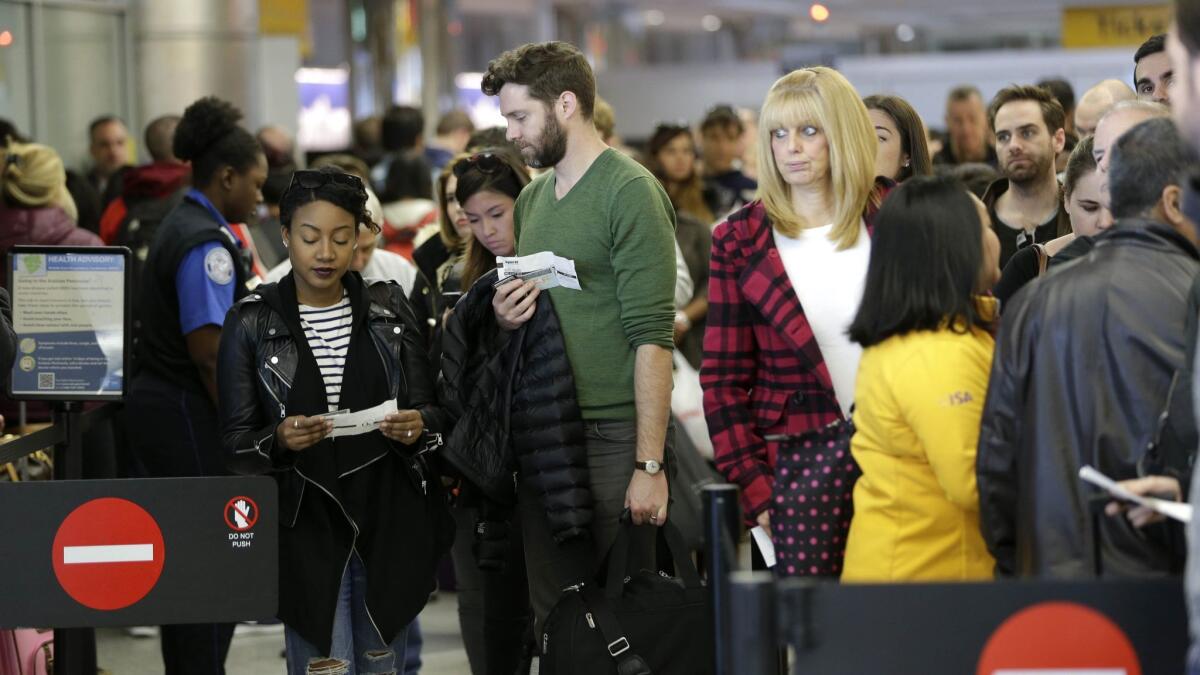 Passengers wait in a security line at LaGuardia Airport in New York on Nov. 25, 2015. An airline trade group predicts 27.3 million people will travel on U.S. airlines for the Thanksgiving holiday.