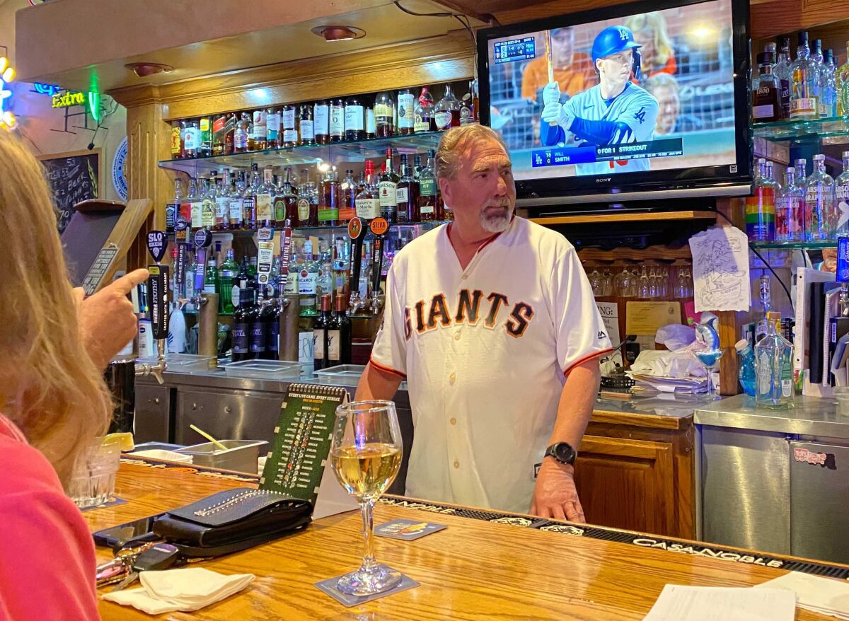 Gary Neal, co-owner of West End Bar & Grill in Cambria, watches his Giants beat the Dodgers Friday night. 