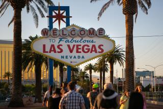 LAS VEGAS, NV - MAY 12: People stop to take photos at the iconic Welcome to Las Vegas sign as Las Vegas plans its grandiose reopening after battling the pandemic on Wednesday, May 12, 2021 in Las Vegas, NV. (Jason Armond / Los Angeles Times)