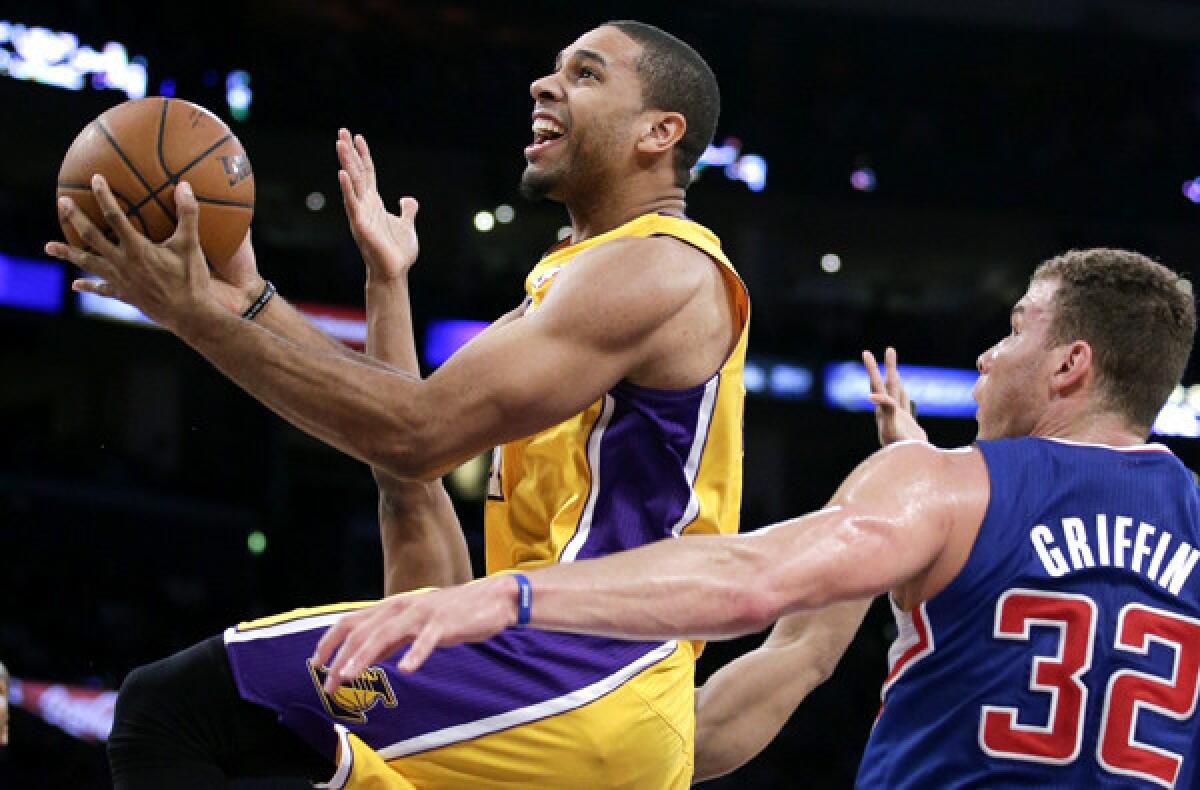 Lakers swingman Xavier Henry drives past Clippers forward Blake Griffin for a layup during a game last season at Staples Center.