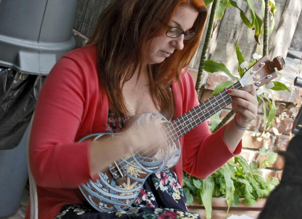 Beachcombers Kate's Ukes member Alissa Hunnicutt of Burbank plays along to songs at Java Brew Coffee House, 2418 Honolulu Ave., in Montrose on Saturday, September 21, 2013.