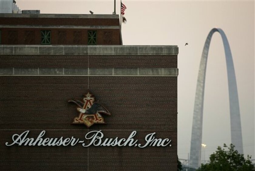 In this July 14, 2008 file photo, the Anheuser-Busch brewery is seen in the foreground as the Gateway Arch is seen in the distance in St. Louis. Ten angry beer drinkers have filed a federal lawsuit Wednesday, Sept. 10, 2008, claiming Belgium-based InBev's $52 billion purchase of Anheuser-Busch Cos. Inc. would violate U.S. antitrust law if completed as planned in the coming months. (AP Photo/Jeff Roberson, file)