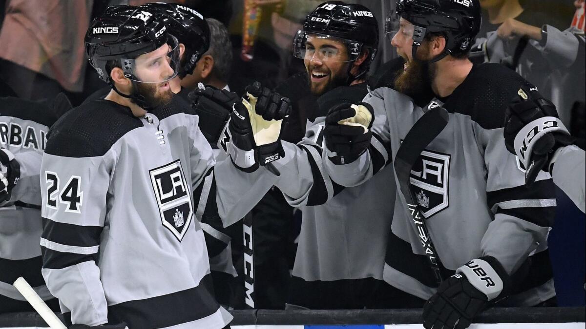Kings' Derek Forbort (24) celebrates his goal with teammates to take a 4-1 lead over the Vegas Golden Knights during the third period on Saturday at Staples Center.