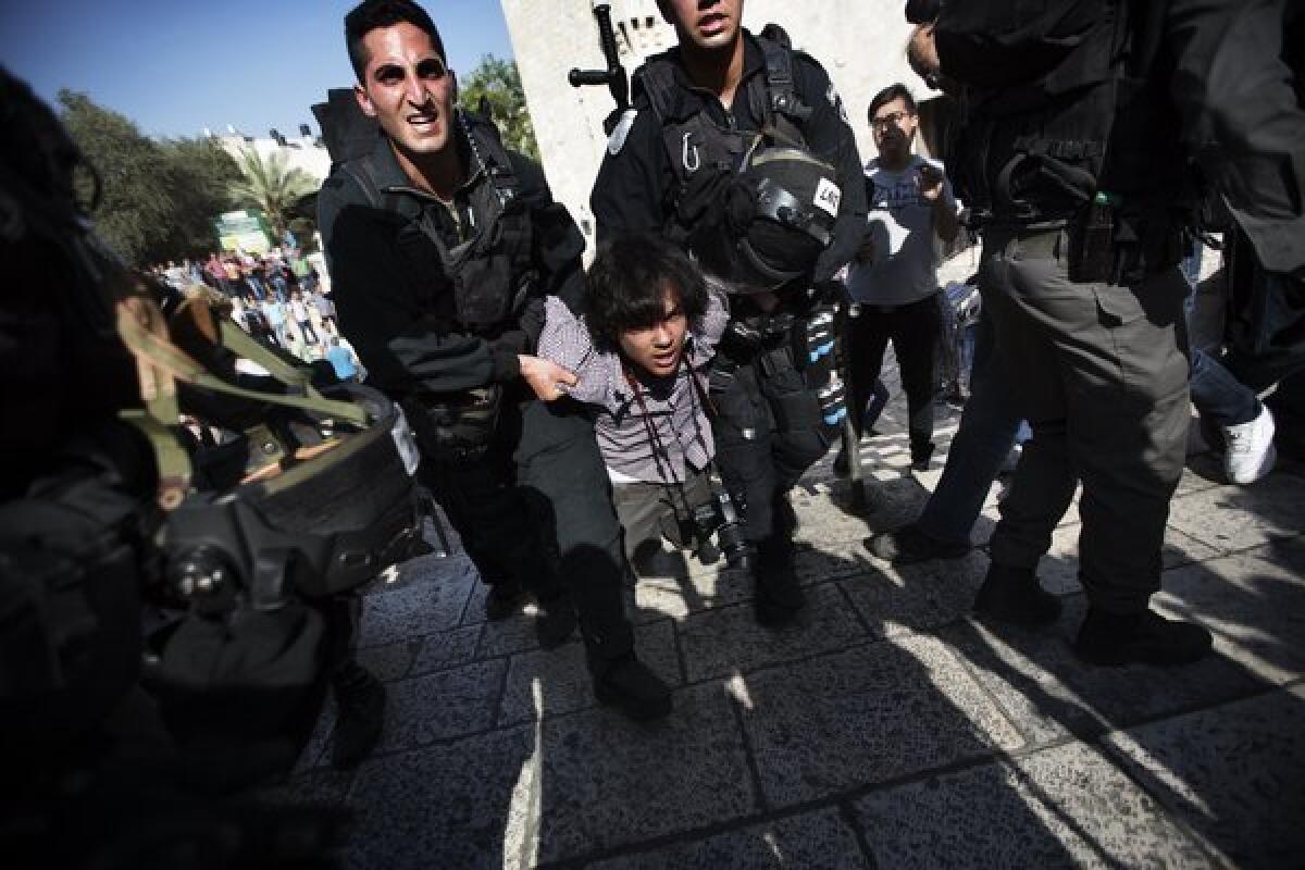 A young man is arrested by Israeli border police following a protest against Israelis celebrating Jerusalem Day on Wednesday at the Damascus Gate in Jerusalem's Old City.