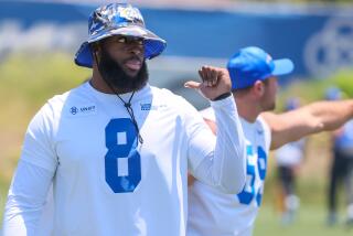 Rams linebacker Jared Verse (8) points to himself on the practice field.