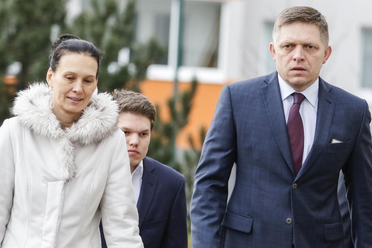 Slovak Prime Minister Robert Fico, his son Michal Fico and his wife Svetlana Ficova arrive to vote in Bratislava.