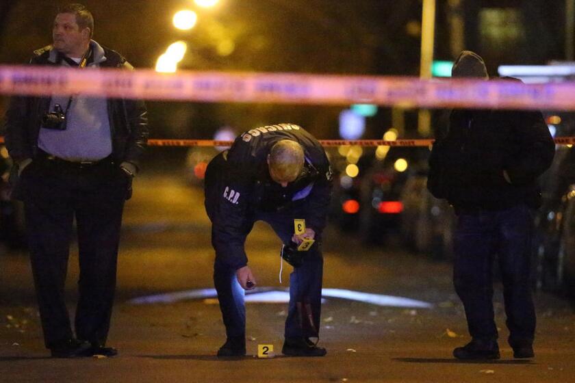 Members of the Chicago Police Department investigate the scene of a shooting on Wednesday night. It was the city's 701st homicide of 2016.