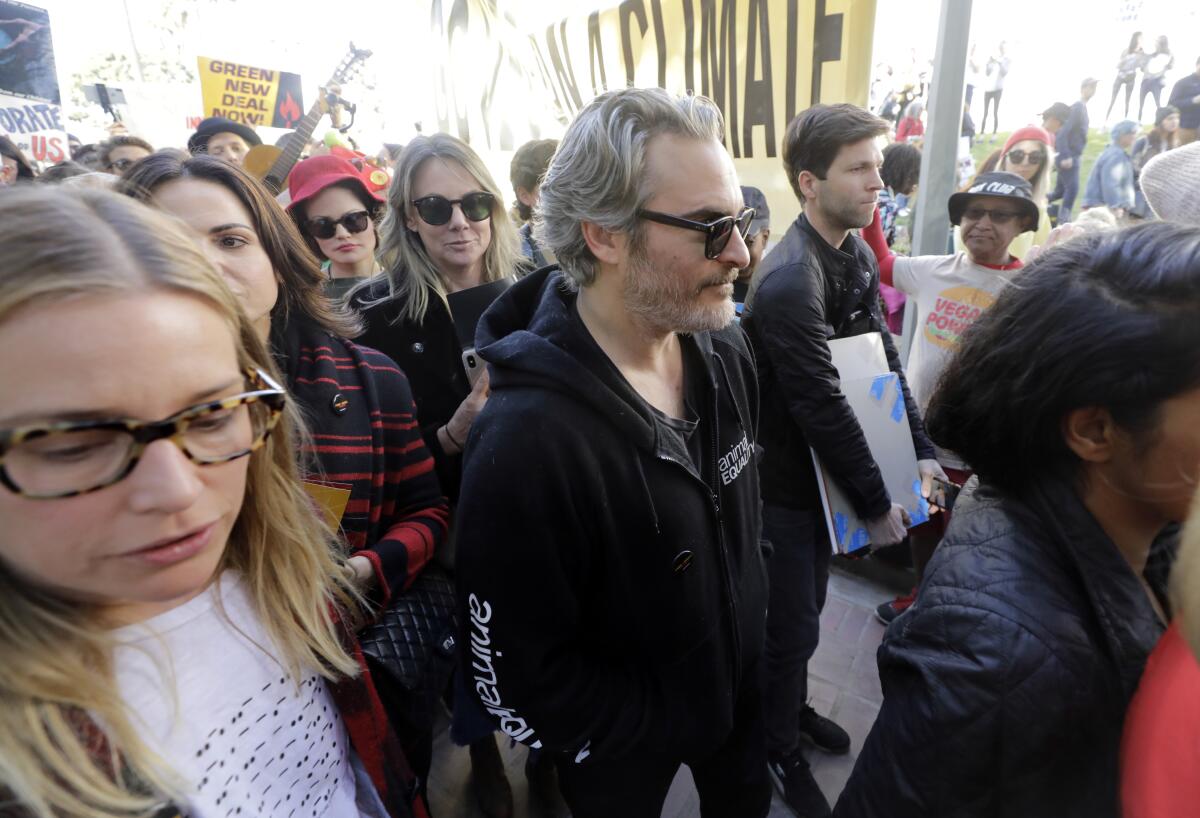 Actor Joaquin Phoenix was among protesters Friday in front of City Hall.