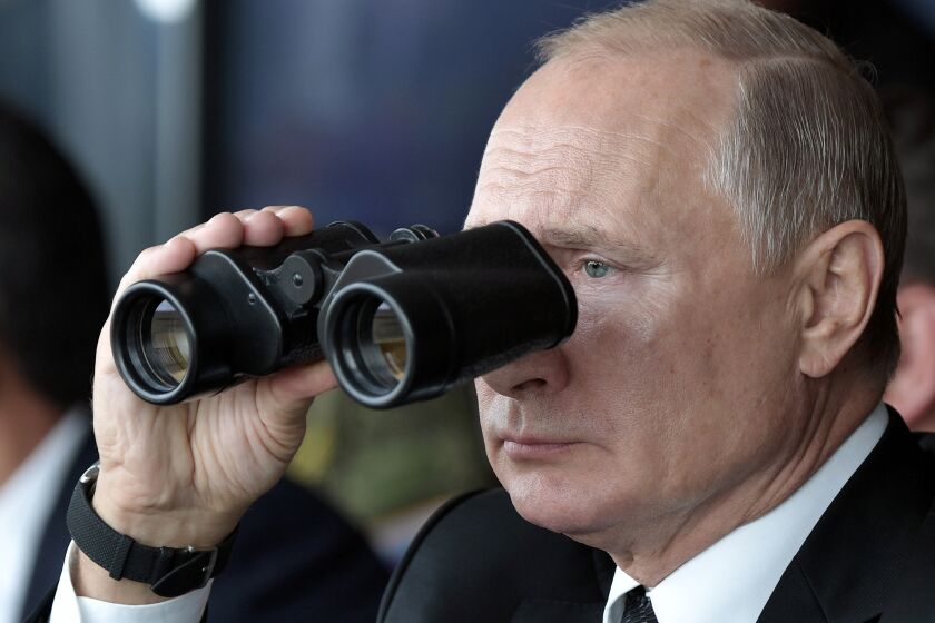 FILE - Russian President Vladimir Putin holds binoculars while watching the military exercises Center-2019 at Donguz shooting range near Orenburg, Russia, in Sept. 20, 2019. Russian President Vladimir Putin has warned that he wouldn't hesitate to use nuclear weapons to ward off Ukraine's attempt to reclaim control of its occupied regions that Moscow is about to absorb. (Alexei Nikolsky, Sputnik, Kremlin Pool Photo via AP, File)