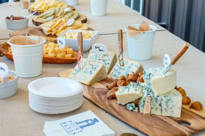 A selection of cheese, with several wedges of blue cheese in the foreground