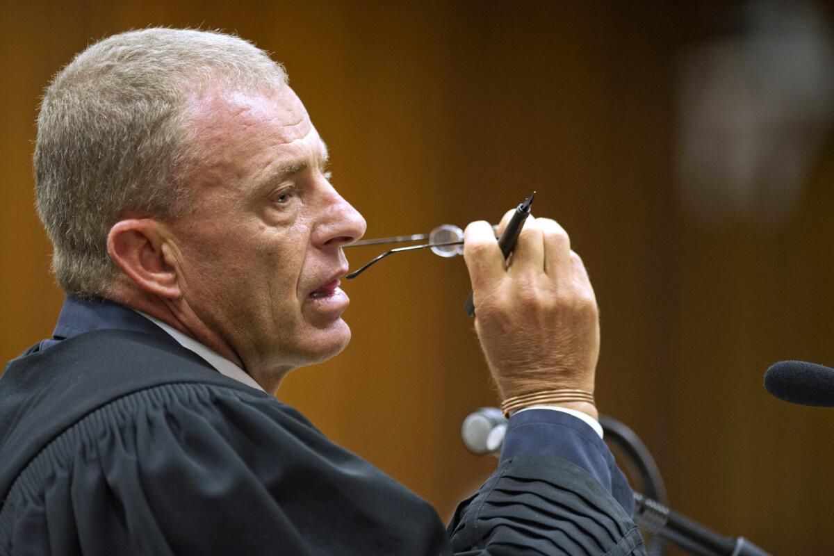 State prosecutor Gerrie Nel questions Oscar Pistorius in court in April in Pretoria, South Africa.