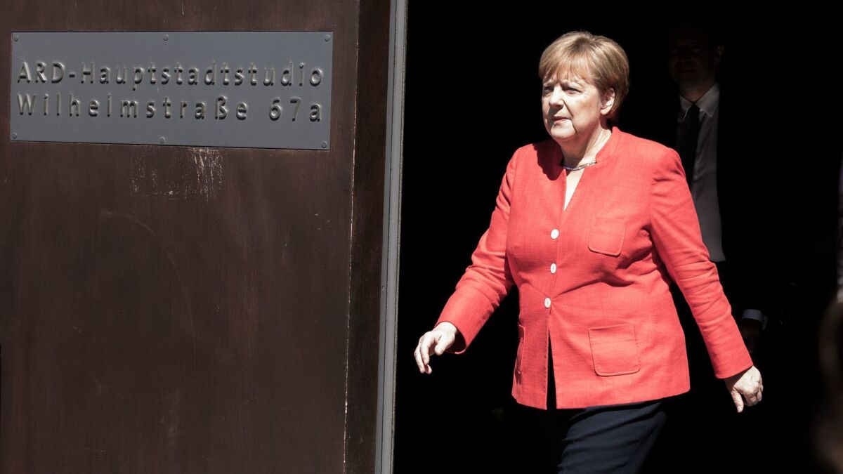 German Chancellor Angela Merkel leaves the studios of German public television station ARD on Wednesday in Berlin after having recorded an interview to be broadcast later in the day.