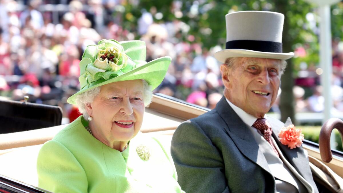 Queen Elizabeth II and Prince Philip arrive with the royal procession as they attend the Royal Ascot opening on June 20. A few hours later, Philip was admitted to King Edward VII Hospital.