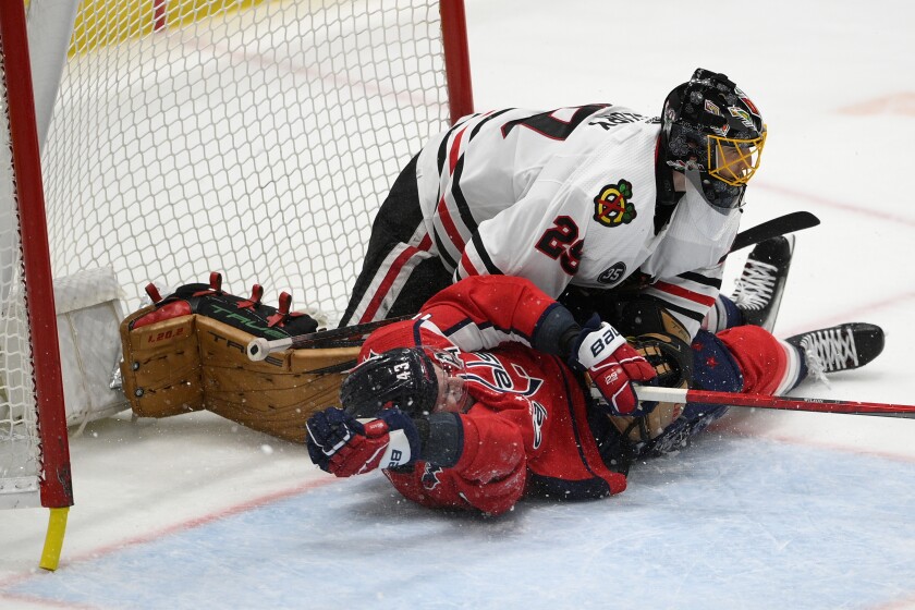 Washington Capitals right wing Tom Wilson (43) slides into Chicago Blackhawks goaltender Marc-Andre Fleury (29) during the third period of an NHL hockey game, Thursday, Dec. 2, 2021, in Washington. The Blackhawks won 4-3 in a shootout. (AP Photo/Nick Wass)