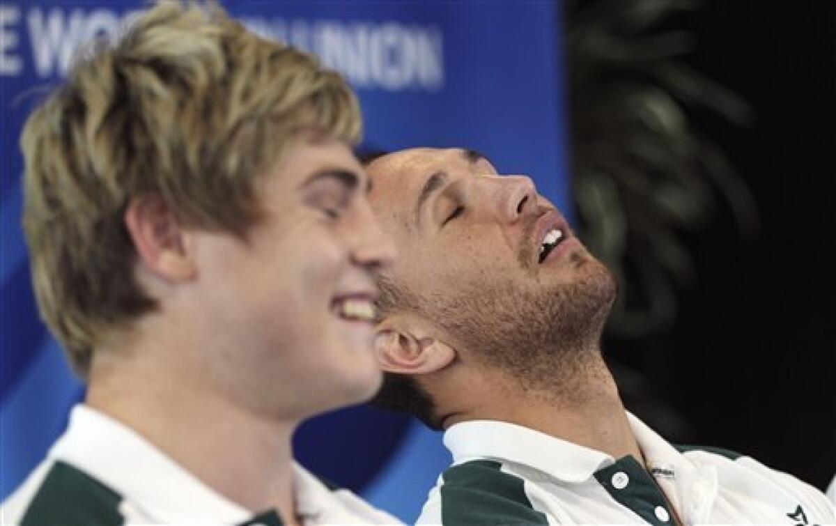 Australia rugby player Quade Cooper right, pretends to fall asleep as teammate James O'Connor answers questions during a press conference in Wellington, New Zealand, Wednesday, Oct. 5, 2011. Australia will play South Africa in the Rugby World Cup quarterfinals on Sunday Oct. 9.(AP Photo/Rob Griffith)