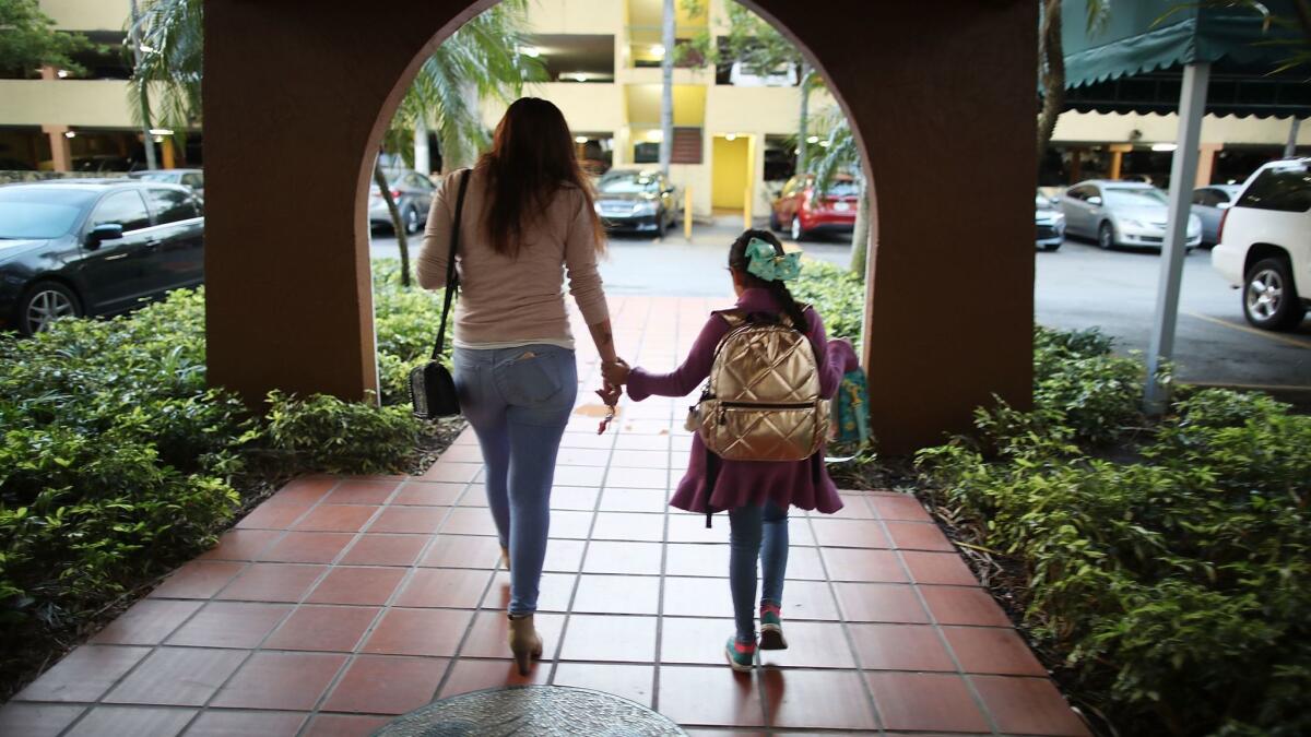 Lorena Jofre walks with her daughter before 7 a.m t.o take her to school before driving to work in Miami. Jofre is one of approximately 800,000 immigrants that fall under the category of Deferred Action for Childhood Arrivals (DACA).