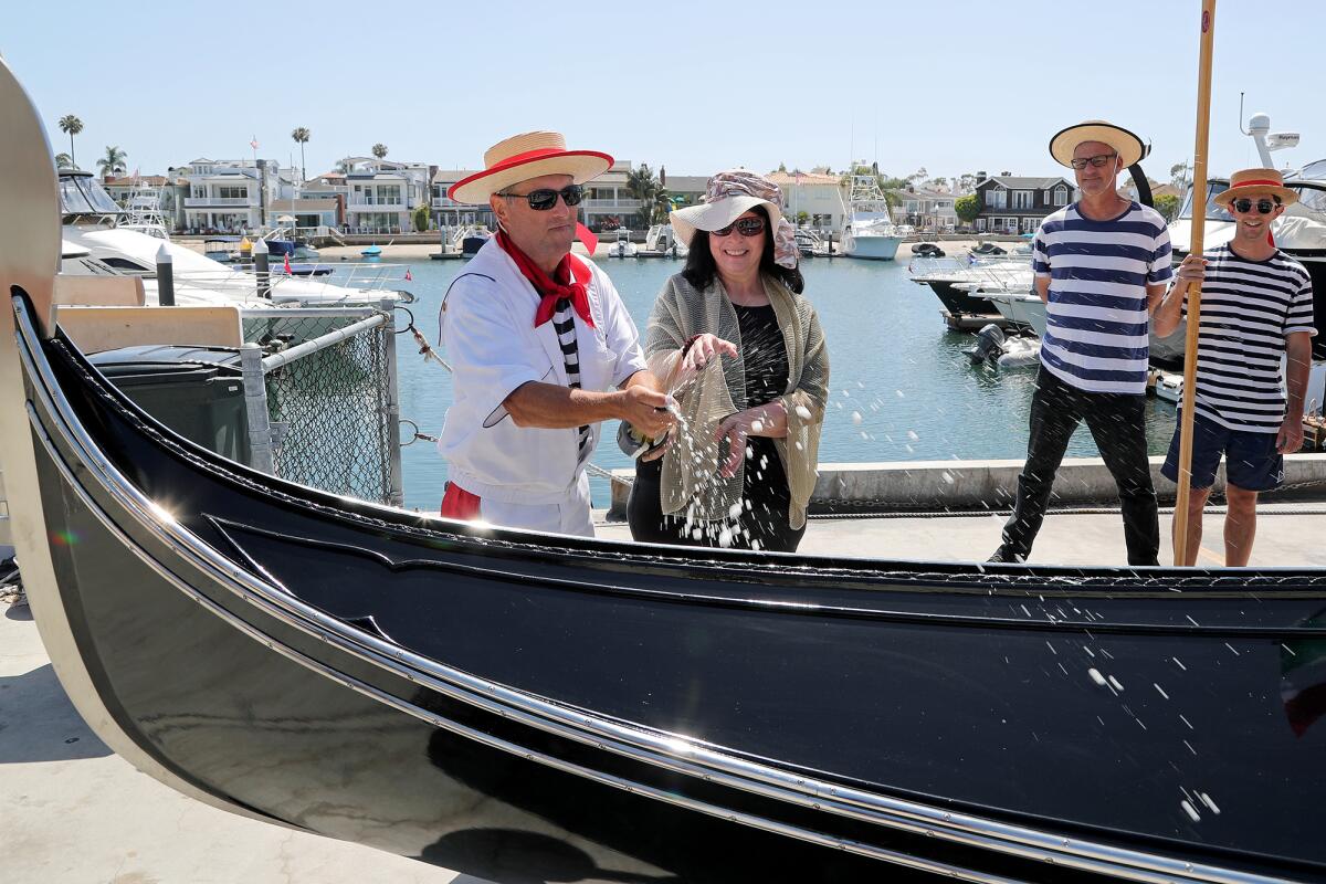 Greg Mohr and his wife, Elisa, christen Luna, one of two new Venice-built gondolas.