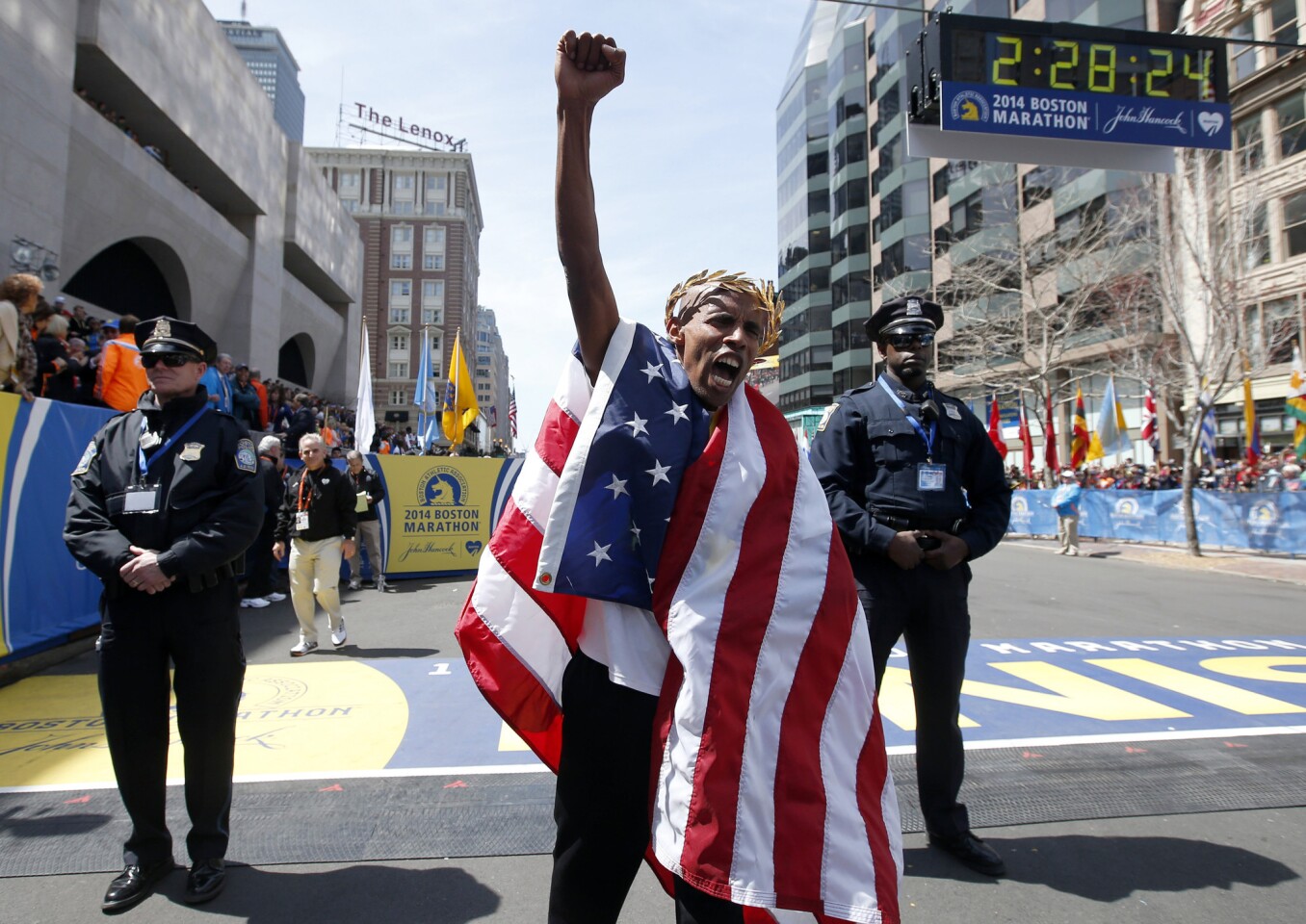 Meb Keflezighi of San Diego celebrates his victory in the 118th Boston Marathon on April 19, a year after deadly bombings struck the event. Keflezighi became the first American man to win the race since 1983.