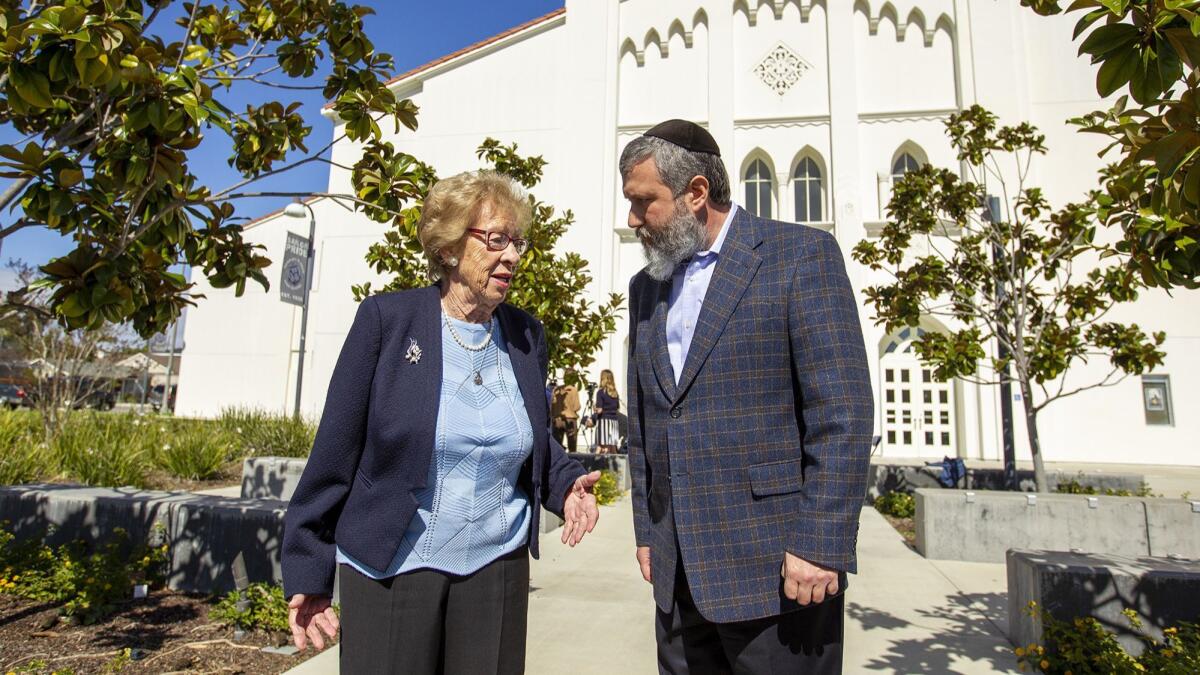 Eva Schloss, 89, a Holocaust survivor and Anne Frank’s stepsister, speaks with Rabbi Reuven Mintz of the Chabad Center for Jewish Life in Newport Beach after a meeting Thursday at Newport Harbor High School with students involved in a party featuring Nazi symbolism.