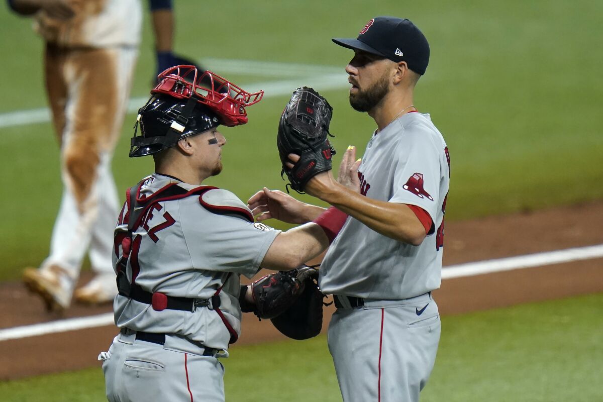 Boston Red Sox catcher Christian Vazquez, left, and pitcher Matt Barnes celebrate after clsoing out the Tampa Bay Rays during the ninth inning of a baseball game Thursday, Sept. 10, 2020, in St. Petersburg, Fla. (AP Photo/Chris O'Meara)