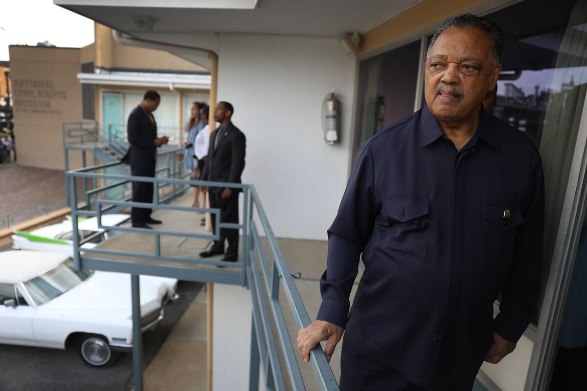 On Tuesday, the Rev. Jesse Jackson pauses on the balcony outside room 306 at the Lorraine Motel in Memphis, Tenn. It was the spot where he was standing when Martin Luther King Jr. was assassinated 50 years ago.