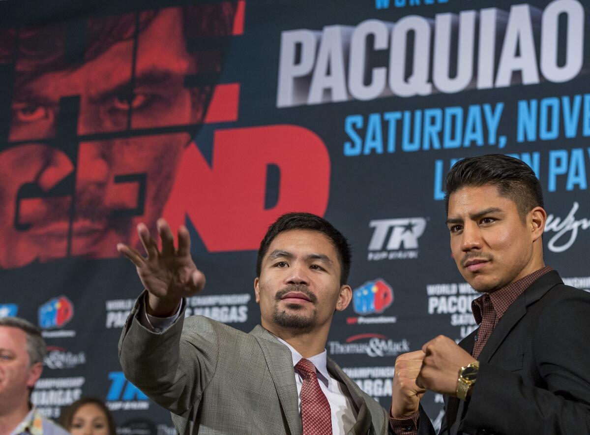 Manny Pacquiao, left, and Jessie Vargas poses for photos during a news conference in Beverly Hills, Calif., on Thursday, Sept. 8, 2016., about their WBO welterweight title fight scheduled for Nov. 5. (AP Photo/Damian Dovarganes)