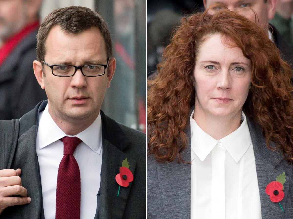 Andy Coulson and Rebekah Brooks arrive at London's Old Bailey courthouse for an Oct. 31, 2013, session in their phone-hacking trial.