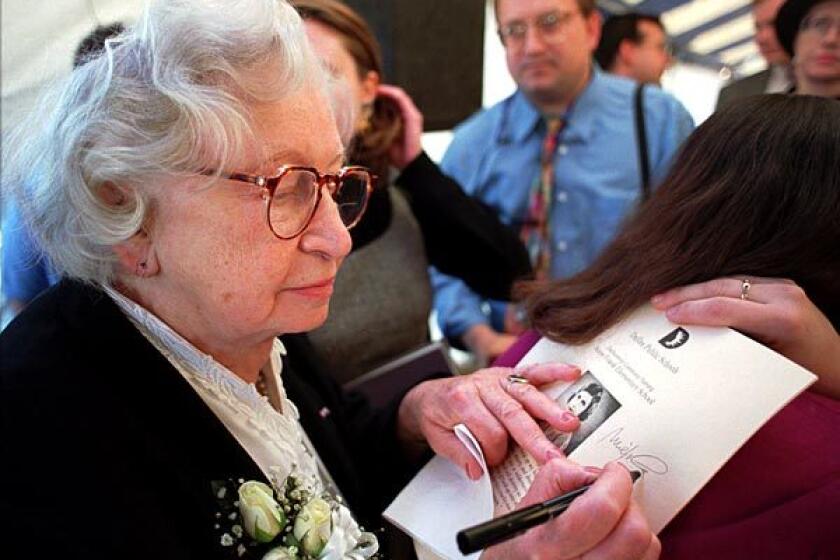 Miep Gies signs a program at the dedication ceremony for Anne Frank Elementary School in Dallas on Nov. 14, 1995.