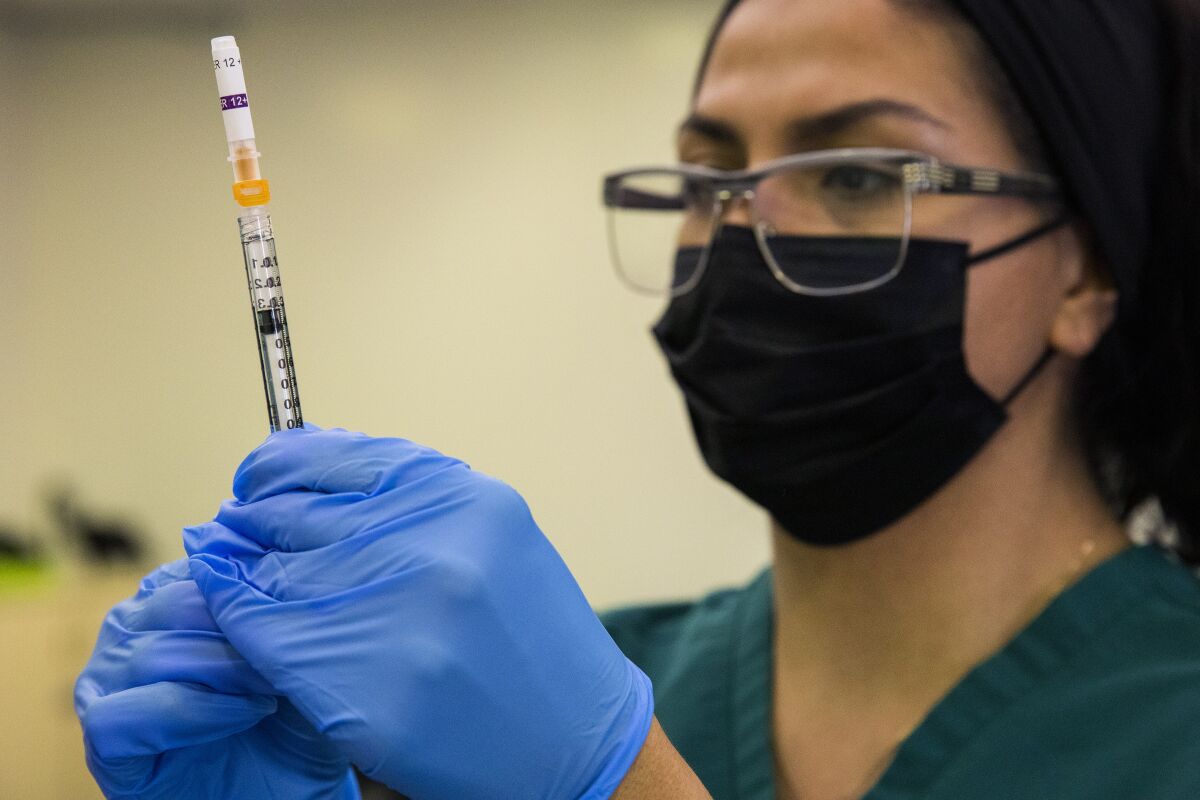 A nurse holding a syringe