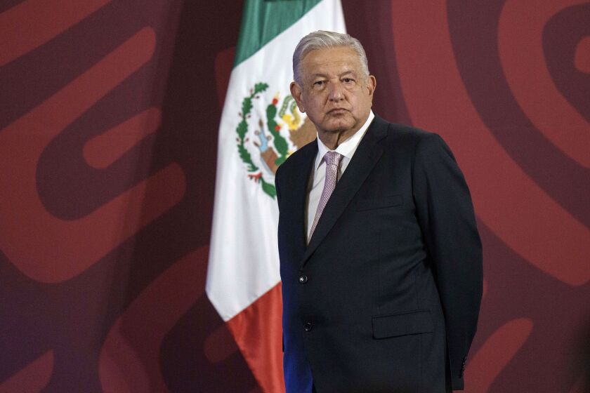 FILE - Mexican President Andres Manuel Lopez Obrador stands on a stage from where he gives his daily press conference at the National Palace in Mexico City, on July 8, 2022. "The best foreign policy is the domestic one," repeats Andres Manuel Lopez Obrador, who speaks daily to the press without any type of filter. (AP Photo/Moises Castillo, File)