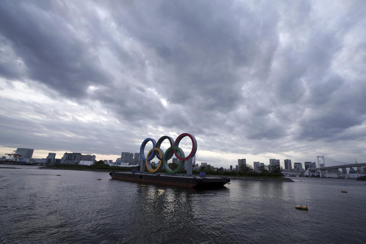 A representation of the Olympic rings floats on a raft