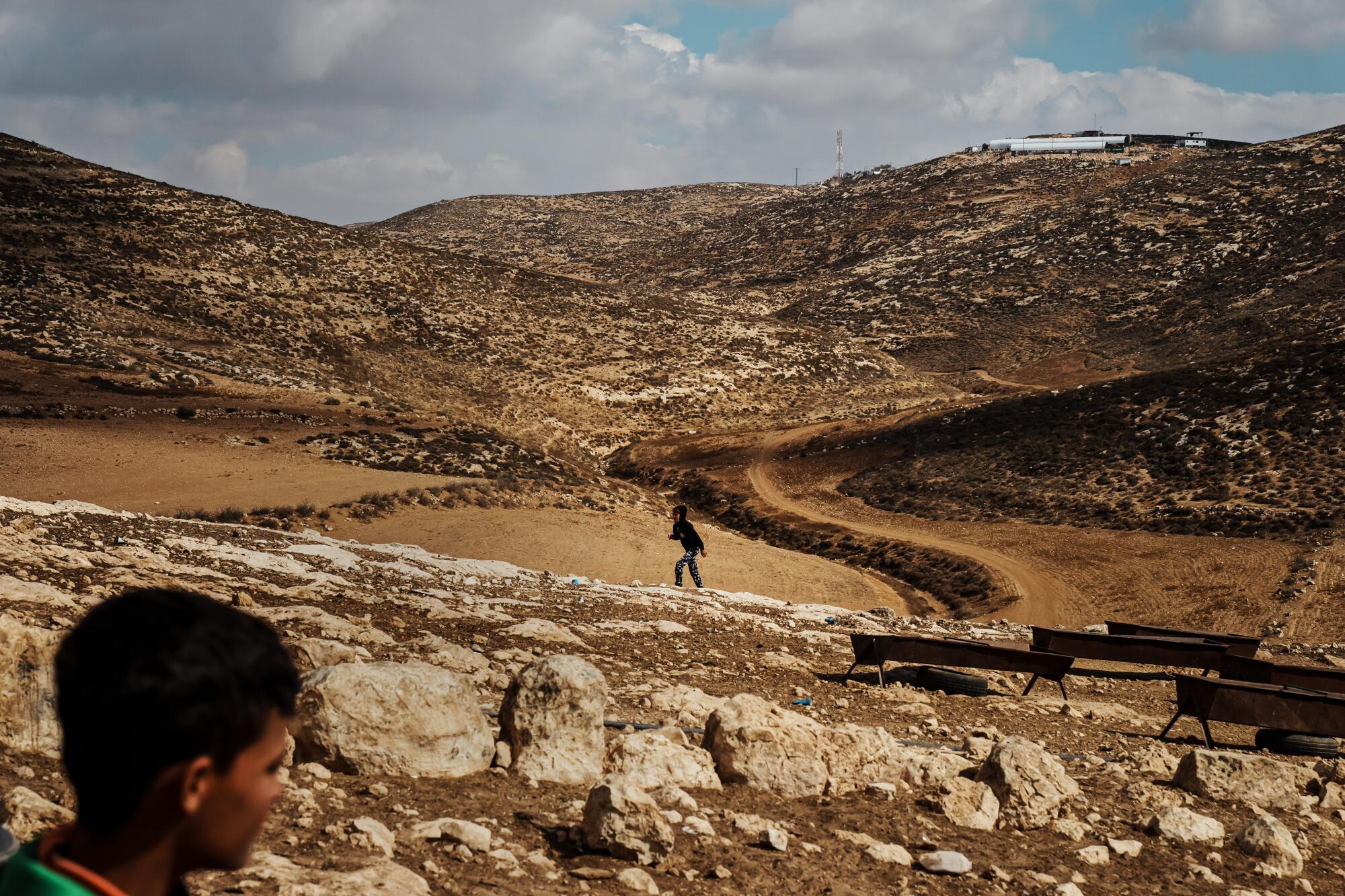 Israeli settlement that was build in the recent years on a hilltop as Palestinian children roam the hilly farmlands.