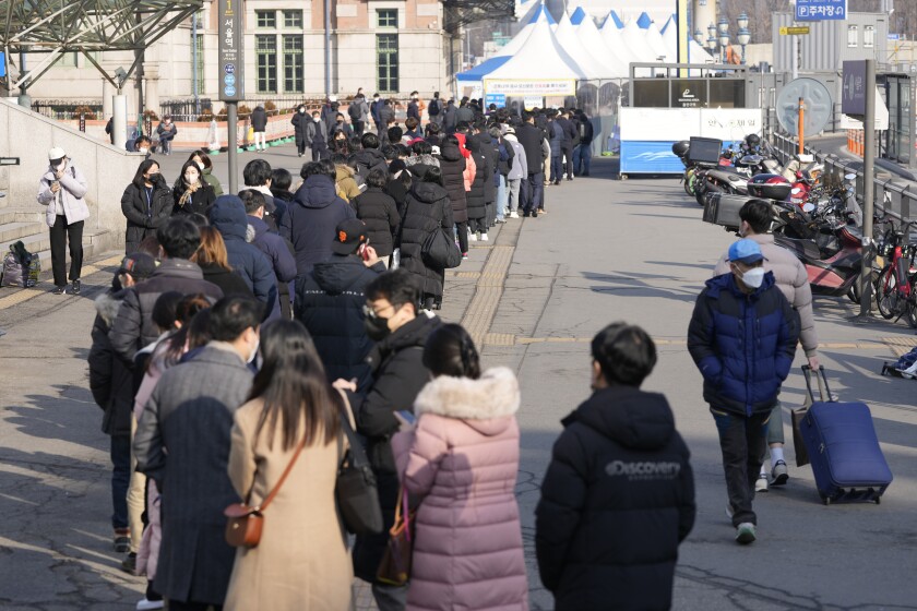 People queue in line for the coronavirus test at a temporary screening clinic for the coronavirus in Seoul, South Korea, Thursday, Jan. 27, 2022. (AP Photo/Lee Jin-man)