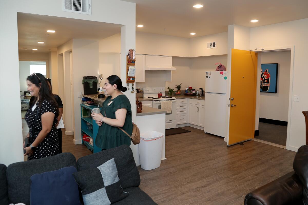 Guests view a three-bedroom unit as they take a tour of Prado, an affordable housing community, on Wednesday.