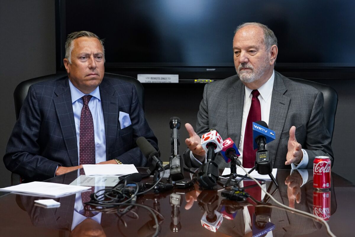 Attorneys Daniel Chamberlain, left, and Melvin Hewitt, Jr. announce a lawsuit in Indianapolis, Monday, April 11, 2022 on behalf of five families of the victims murdered in a mass shooting at the Indianapolis FedEx Ground facility on April 15, 2021. (AP Photo/Michael Conroy)
