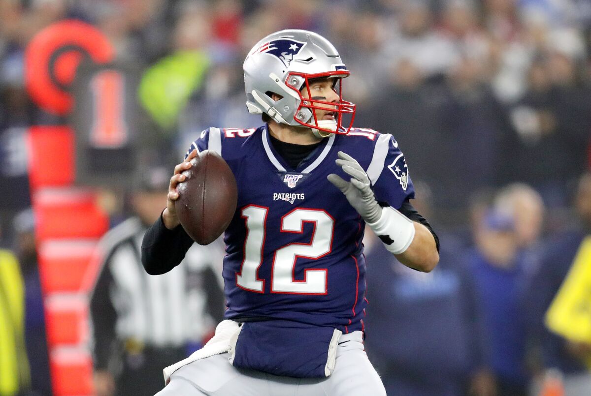 New England Patriots quarterback Tom Brady readies to pass the ball.