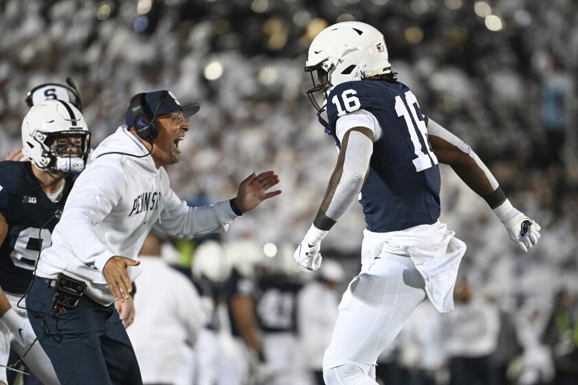 Penn State head coach James Franklin, left, celebrates with tight end Khalil Dinkins (16) after his touchdown against Iowa during the first half of an NCAA college football game, Saturday, Sept. 23, 2023, in State College, Pa. (AP Photo/Barry Reeger)