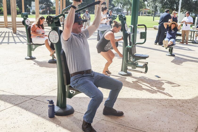 Imperial Beach, CA - September 01: Deputy city manager Tyler Foltz tries out new fitness equipment after a ribbon cutting as part of larger spending plan at Veterans Park on Thursday, Sept. 1, 2022 in Imperial Beach, CA. (Eduardo Contreras / The San Diego Union-Tribune)