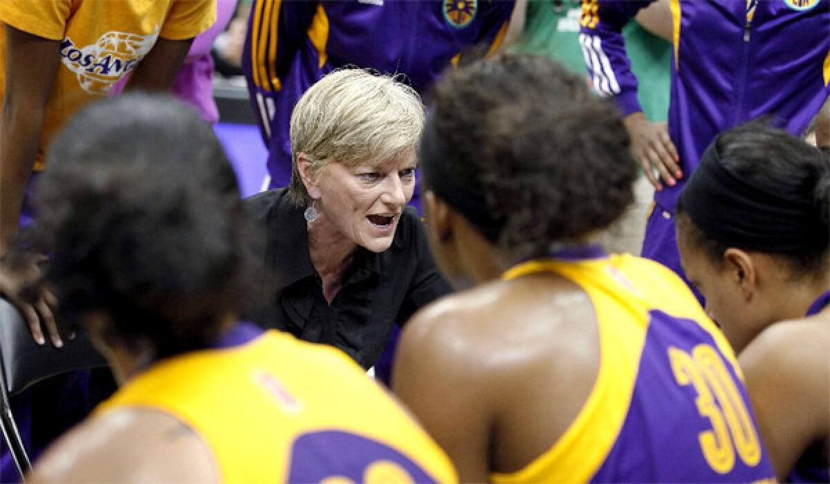 Los Angeles Sparks Coach Carol Ross huddles with her team during the first half of a basketball game against the Minnesota Lynx on June 28, 2013.
