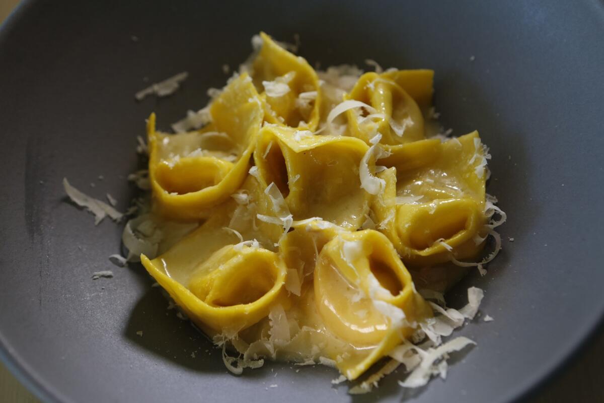 Tortellini in Brodo "al contrario" features tortellini filled with hot broth. The diced mortadella and Parmesan cheese are in the sauce, rather than in the pasta.