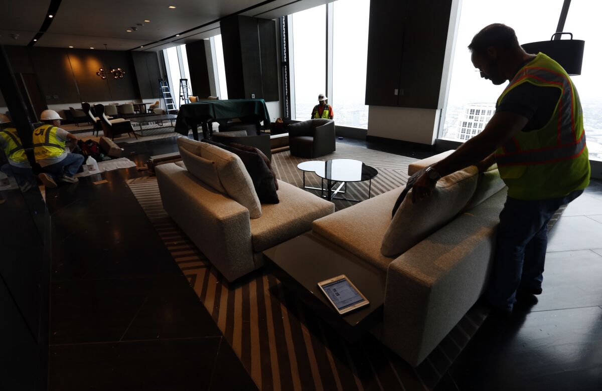 Interior designer Gary Broeker decorates the Presidential suite on the 66th floor of the InterContinental Los Angeles Downtown hotel at the Wilshire Grand Center.