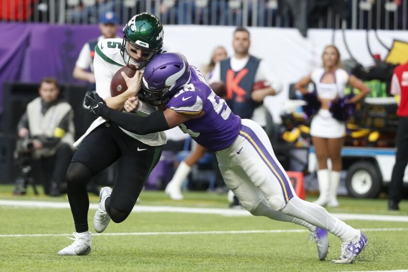 New York Jets quarterback Mike White (5) is tackled by Minnesota Vikings linebacker Jordan Hicks (58) during the second half of an NFL football game, Sunday, Dec. 4, 2022, in Minneapolis. (AP Photo/Bruce Kluckhohn)