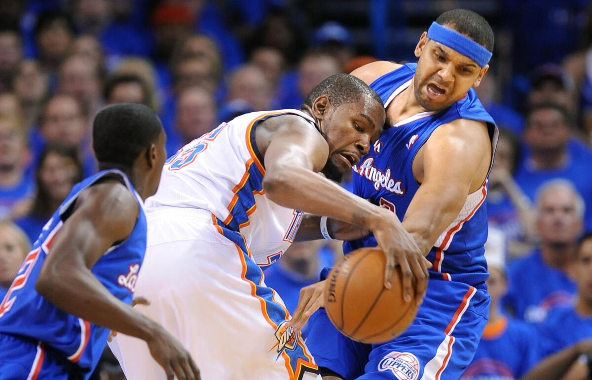 Clippers forward Jared Dudley tries to steal the ball from Thunder forward Kevin Durant in the first half.