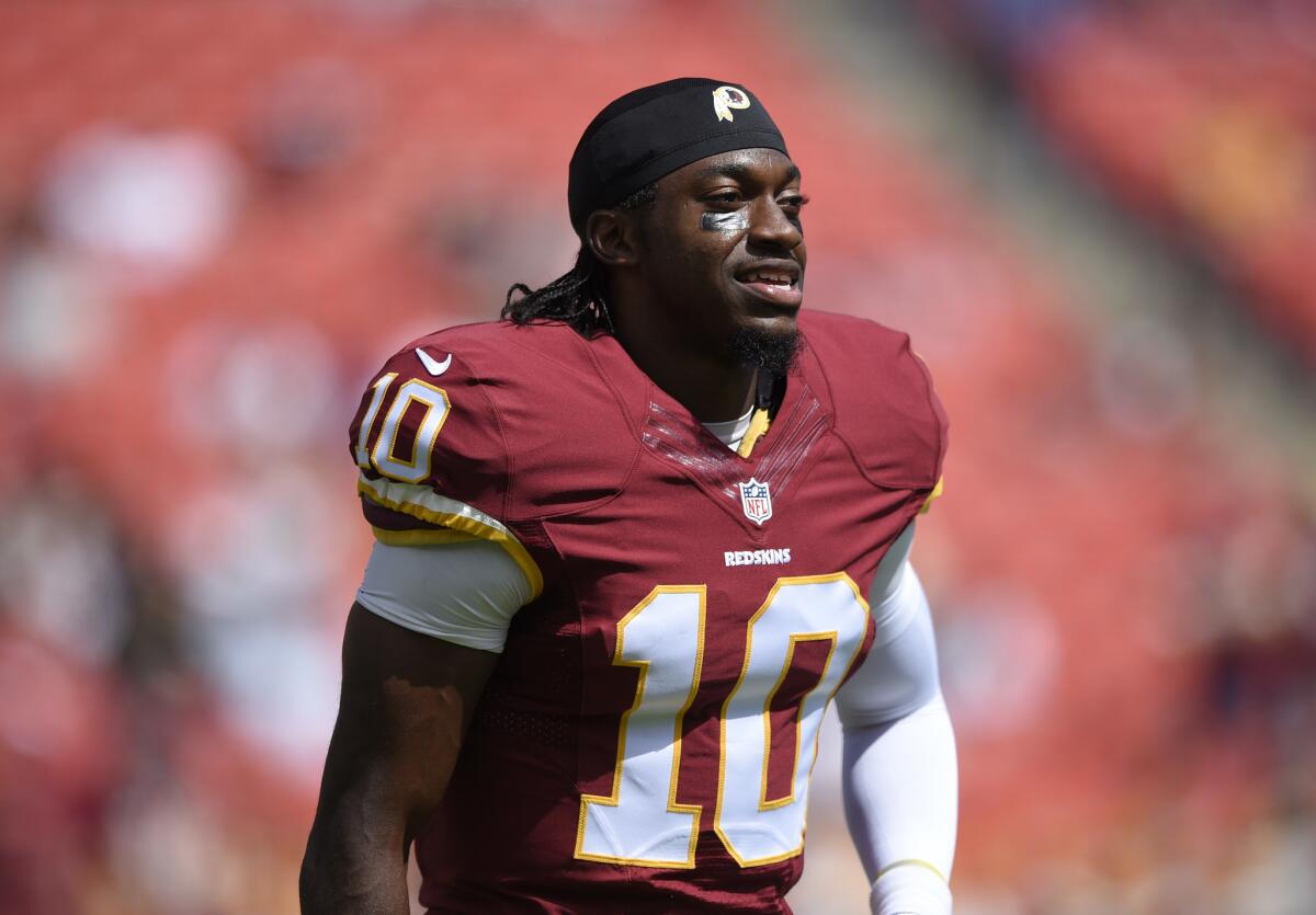 Washington Redskins quarterback Robert Griffin III looks on during warm-ups before a game against the Jacksonville Jaguars in Landover, Md., on Sept. 14, 2014.