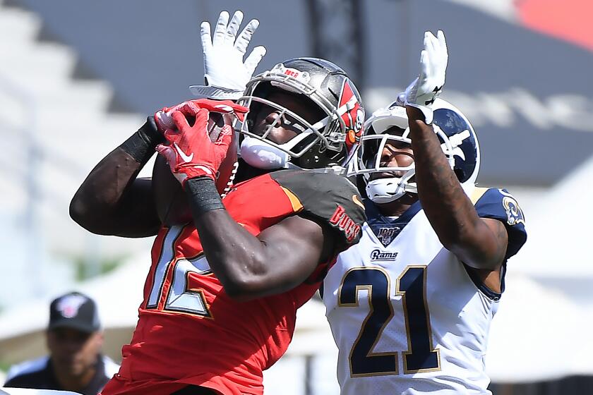 LOS ANGELES, CALIFORNIA SEPTEMBER 29, 2019-Bucaneers receiver Chris Goodwin makes a catch in front of Rams cornerback Aqib Talib in the 1st quarter at the Coliseum Sunday. (Wally Skalij/Los Angeles Times)