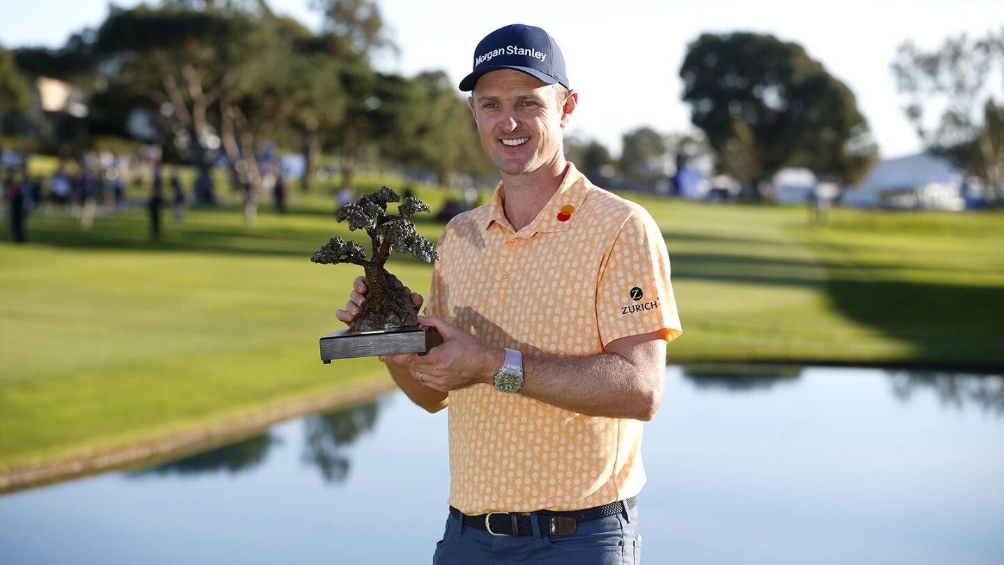 Justin Rose holds the trophy after winning the Farmers Insurance Open at the Torrey Pines Golf Course on Jan. 27, 2019. (Photo by K.C. Alfred/San Diego Union-Tribune)
