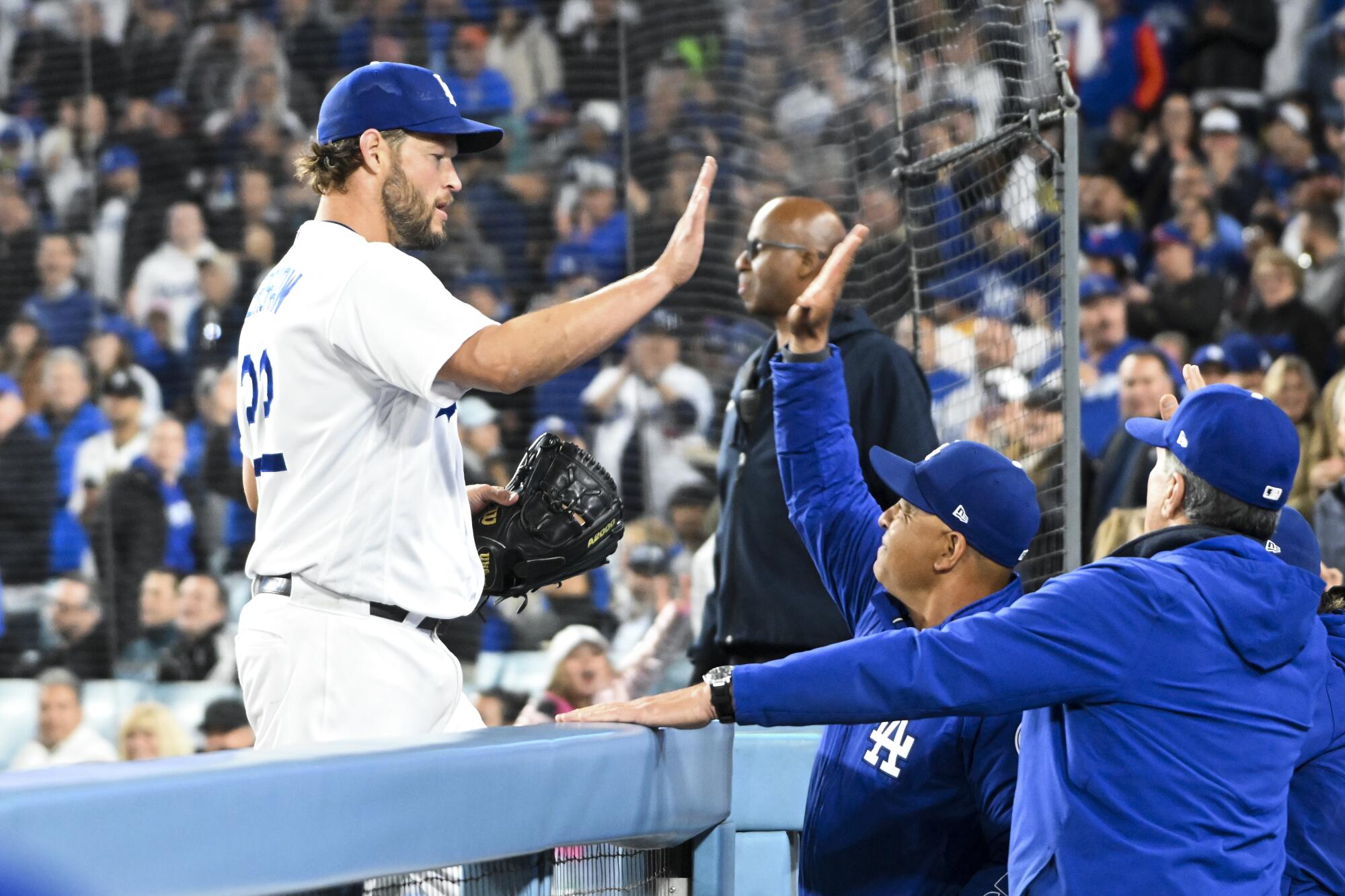 Dave Roberts greets Clayton Kershaw after Kershaw retired the side during the seventh inning.