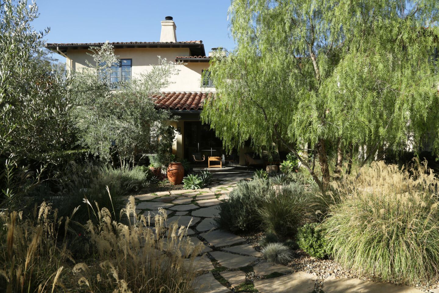The new drought tolerant garden of Amy Lippman and Rodman Flender extends the footprint of the Spanish home.