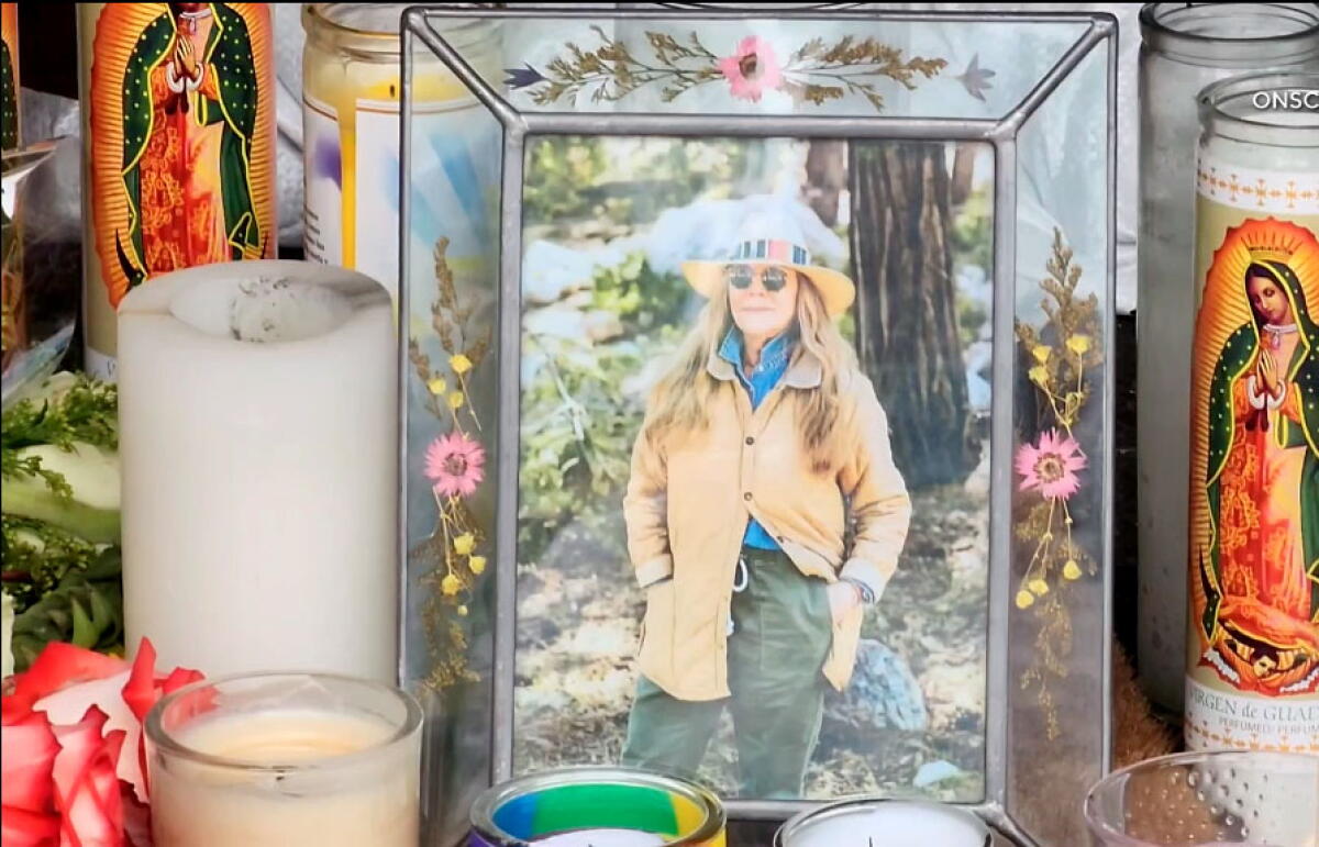 A photo of Mag.pi owner Laura Ann Carleton is placed among the candles outside the store on Aug. 19, 2023 in Cedar Glen. (ONSCENE.TV)